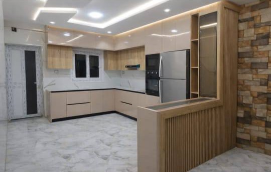 Cuisine HR Cuisine beige laquee, mur en pierre et caisson cannele